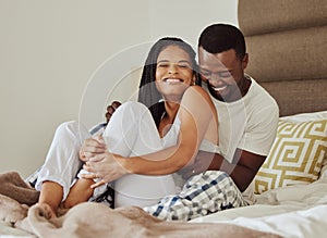 Love, black couple on bed and play together for bonding, loving and romantic weekend. Romance, man and woman in bedroom