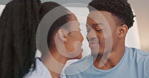 Love, black couple and kiss on bed in bedroom home with romance, intimacy and laugh. Trust, commitment and support of