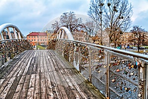 Love bridge in Bydgoszcz, Poland, Love lock padlock sweethearts locked, old town houses with footbridge, bridge Jana Kiepury over