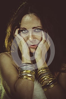 Love, brunette woman wearing white fur and gold jewelry