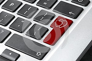 Love button on laptop keyboard, closeup. Online dating site