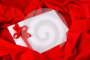 Love card with ribbon on a red fabric