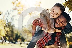 Love, care and interracial couple with piggyback in a park for support, adventure and happy with mockup and bokeh. Hug