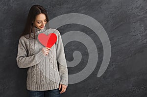 Kind woman with red paper heart photo