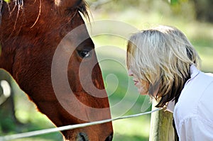 Love and care between lady and pet horse