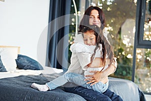 Love of child and parent. Mother and her daughter spending time together at home