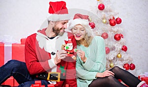 We love christmas. Couple in love enjoy christmas holiday celebration. Family wear santa hats. Loving couple cuddle