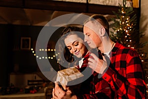 Love, christmas, couple, proposal concept - happy man giving diamond engagement ring to woman