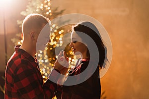 Love, christmas, couple, proposal and people concept - happy man giving diamond engagement ring to woman at home