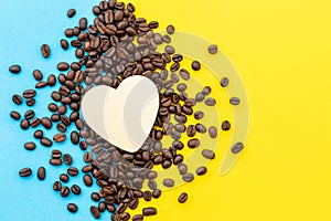 Love coffee concept, Top view white heart on the coffee grain on yellow