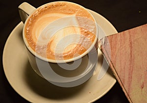 Love coffee,A cup of latte art with heart pattern in a white cup.Indoor cafe