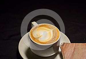 Love coffee,A cup of latte art with heart pattern in a white cup.Indoor cafe