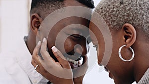 Love, commitment and happy black couple touching heads while standing together and sharing a romantic moment. Closeup of