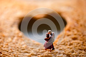 Love Concept. Miniature of Senior Elderly Couple on Toasted Bread with a shape of Heart