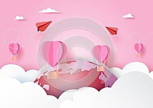 Love concept with red couple airplane and pink hot air balloons floating on clouds,world and pink sky paper art style.Vector