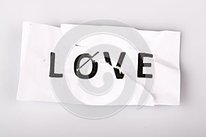love concept on torn and stapled paper