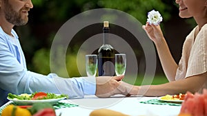 Love confession of middle-aged man on romantic dinner with woman, holding hand