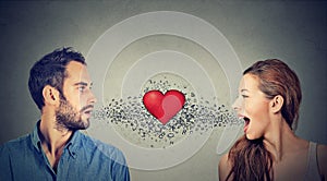 Love connection. Man woman talking to each other red heart in-between