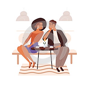 Love couple in cafe on date. Happy woman and charmed man sitting at table with coffee cups, looking at each other