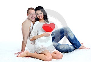 Love couple on the floor with a big red heart