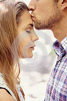 Love, couple and forehead kiss, park and happiness for relationship, dating and quality time outdoor. Romance, man and