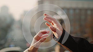 Love couple hands connecting in urban background. Guy and girl holding hands