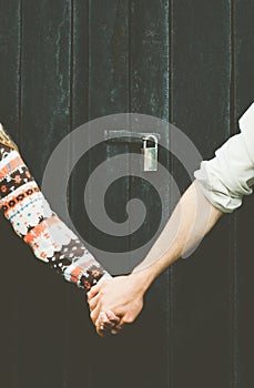 Love Couple hands holding forever together Lifestyle wooden background and lock over people taboo