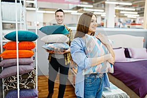 Love couple holds pillows in furniture store