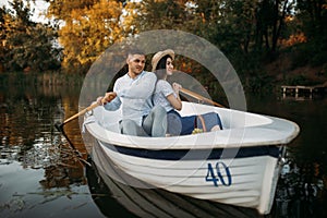 Love couple hugs in a boat on quiet lake