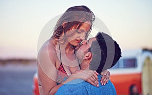 Love, couple and kiss at the beach on date, vacation or road trip in summer with freedom, together and romantic