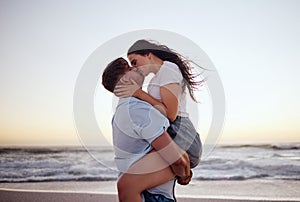 Love, couple and kiss on beach at sunset for romantic and passionate embrace on summer evening date. Dating USA woman