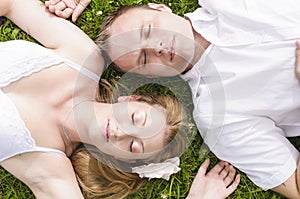Love couple lying in the grass