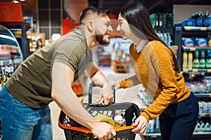 Love couple poses in grocery store