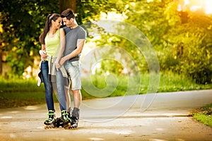 Love couple ride rollerblades in the park