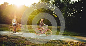 Love couple riding on vintage bicycles in park