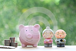 Love couple senior and piggy bank on natural green background, Save money for prepare in future and pension retirement concept
