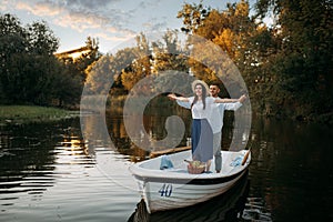 Love couple standing in a boat on quiet lake