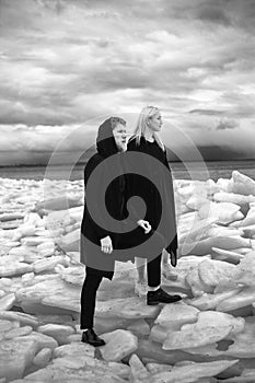 Love Couple stay on the ice floe, Thunder Sky and sea . melting glaciers