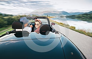 In love couple traveling by cabriolet car