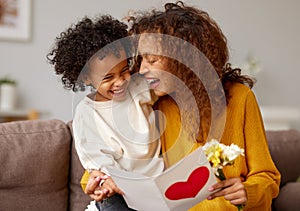 Young mixed race woman getting congratulations from son on Mothers day