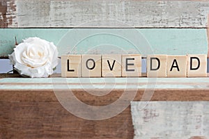 Love dad words with white rose on rustic vintage table