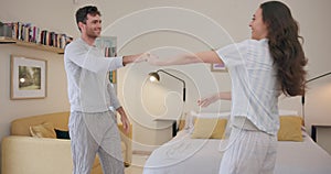 Love, dancing and happy couple in bedroom together, energy and embrace on weekend morning. Music, marriage and romance
