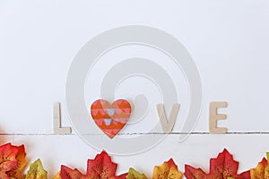 Love day concept. The wooden text remain to valentine`s day with maple leaf and white background.valentine day, february14 photo
