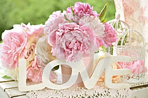 Love decoration with wooden letters and peony flowers with color