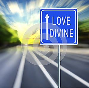 Love Divine Road Sign on a Speedy Background with Sunset.