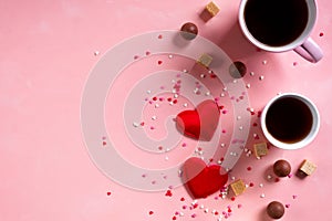 Love drinks. Coffee tea cups, sweets candy chocolate on pink hearts background. Valentines day 14 february minimal
