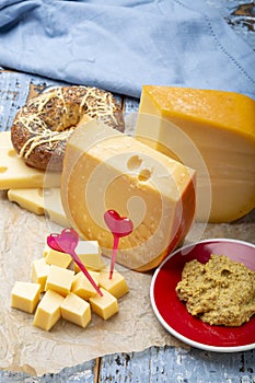 Love Dutch cheese concept, blocks of young and aged Gouda hard cheese