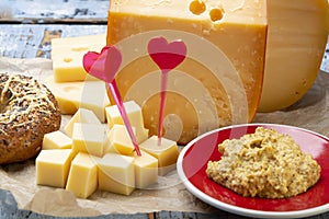 Love Dutch cheese concept, blocks of young and aged Gouda hard cheese