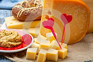 Love Dutch cheese concept, blocks of young and aged Gouda hard cheese