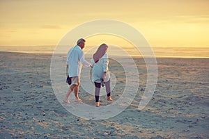 Love each other every step of the way. a mature couple going for a relaxing walk on the beach.